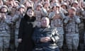 North Korean leader Kim Jong-un poses with his daughter and soldiers in an image released on Sunday.