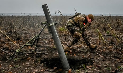 Ukrainian soldiers fire a mortar at a frontline in the Zaporizhzhia region