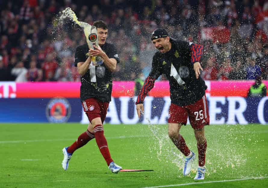 Benjamin Pavard showers Thomas Müller with beer on the pitch