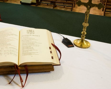Open Bible and crucifix on altar inside church