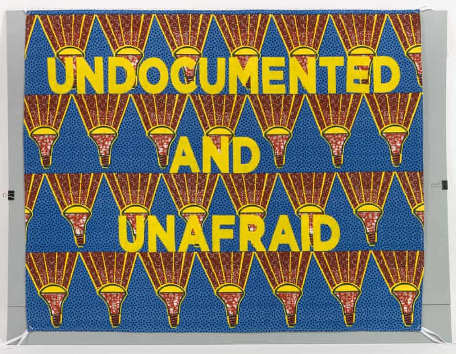 A blue and gold fabric banner has the words 'Undocumented and unafraid' in yellow block letters.