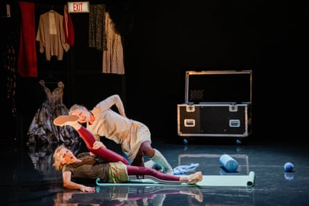Two dancers look troubled as they do warm-up exercises