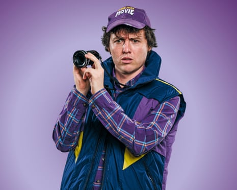 Sam Campbell holding a small camera