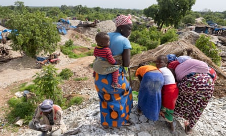 Families sift through the huge mounds of sediment and rock.