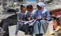 Teacher from Gaza teaches students in the tent school<br>KHAN YUNIS, GAZA - SEPTEMBER 03: Students do homeworks after the lessons at their tent school, in which their teacher Alaa Abu Mustafa, whose house was destroyed in the Israeli army's attacks, gives them education in Khan Yunis, Gaza on September 03, 2024. The tent school was built on the rubble of the destroyed house of the teacher. Despite the limited and difficult conditions, teacher Alaa strives to ensure that primary school students are not deprived of education. (Photo by Hani Alshaer/Anadolu via Getty Images)