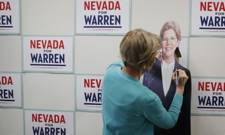 Elizabeth Warren: signs a cardboard cutout of herself.