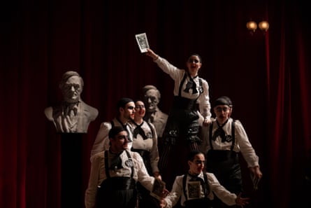 A group of people standing on stage wearing black-and-white outfits.