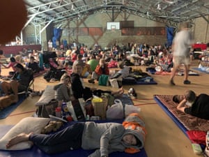 Timothy Lee’s wife, Gwenno Hopkin, and children take shelter in the Narooma Police Citizens Youth Club