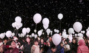 Balloons float over visitors during a New Year's Eve celebration at a Tokyo hotel.