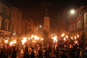 Revellers carry torches