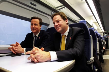 British prime minister David Cameron (left) and his deputy Nick Clegg sitting at a table on a train en route to a coalition cabinet meeting in January 2012