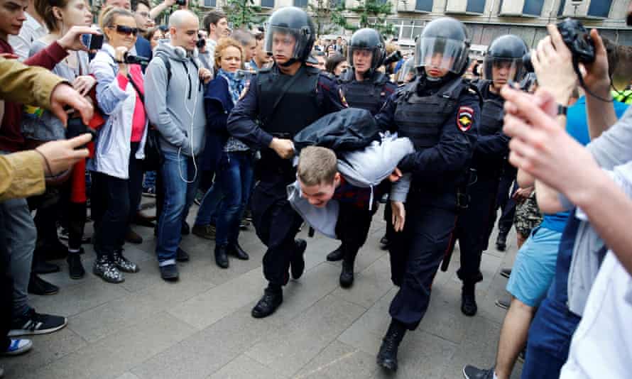 Russian police officers take into custody a protester during an unauthorised opposition rally in Moscow in June last year