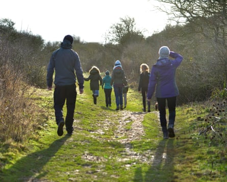 Family on a winter walk on a country trail