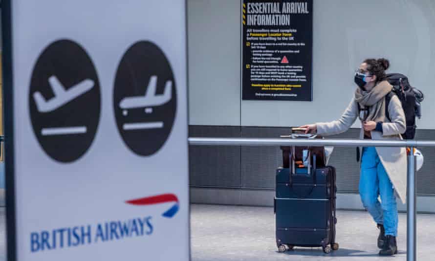 Warning signs about the new rules are on the wall at Heathrow airport, on the day the new quarantine restrictions came in to force for international travel from a red list of countries, 15 February 2021