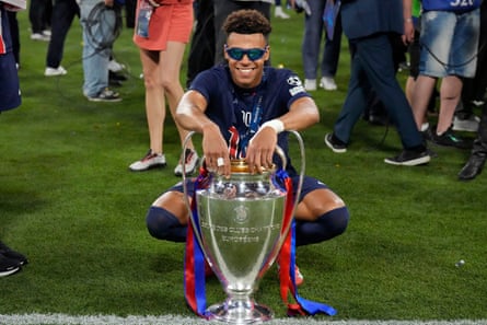 Désiré Doué poses with the European Cup