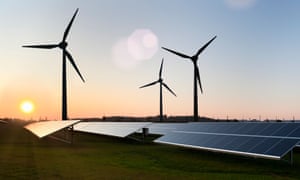Wind turbines and solar panels in field.