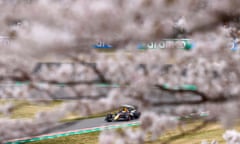 Max Verstappen is seen through cherry blossoms during qualifying at Suzuka.