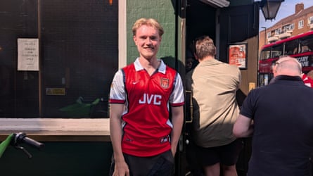 Jack Davenport in an Arsenal shirt outside a pub