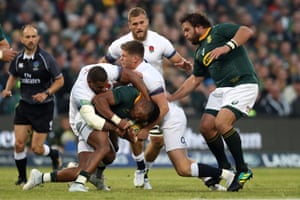 South Africa’s Aphiwe Dyantyi is held in the tackle by Owen Farrell and Kyle Sinckler.
