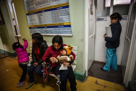 Mothers wait with their children for a medical examination at La Oroya’s health clinic, 2013.