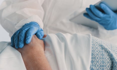 Shot of a doctor using a digital tablet while caring for her senior patient