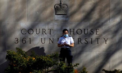 A security guard stands outside the superior court of justice in Toronto, Ontario, during the first day of the trial for accused van attacker Alek Minassian in November.