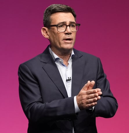 Andy Burnham in shirt and jacket gives speech at Labour conference