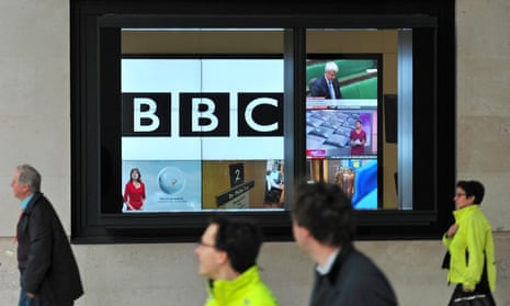 People walk past BBC's New Broadcasting House office in central London.
