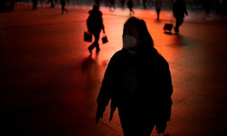 A woman wearing a protective mask walks outside the Shanghai Railway Station, as coronavirus disease  outbreaks continue in Shanghai