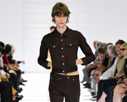 Model wearing a black denim shirt and skinny black jeans