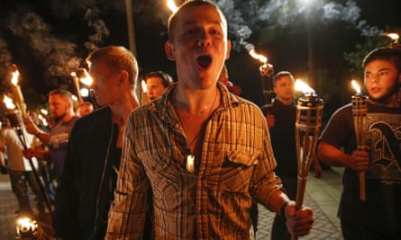 White nationalist groups bearing torches march across the University of Virginia campus in Charlottesville on 11 August 2017