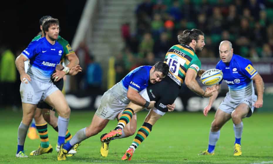 Northampton’s Ben Foden is stopped by a strong tackled from Brad Barritt of Saracens