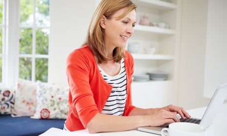 Woman working from home using laptop In kitchen