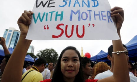 A woman holds a placard as she attends a public gathering in Yangon to listen to Aung San Suu Kyi’s speech