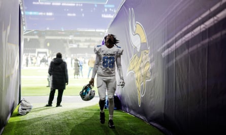 Devon Myrie, a tight end from England for the NFL Academy, walks off the pitch past branding for the Minnesota Vikings after the match against De La Salle Spartans.
