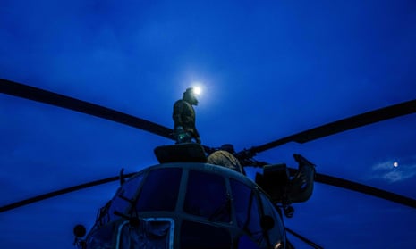 Ukrainian military pilots stand on the top of a helicopter before take off in eastern Ukraine.