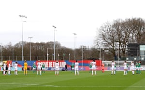Players and officials take part in a minute of applause in memory of Captain Sir Tom Moore.