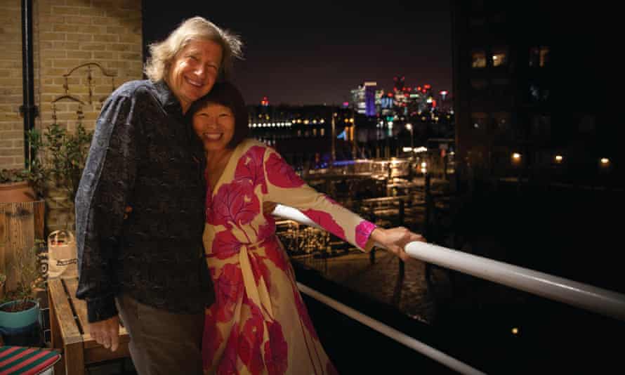 Guy Hibbert and Meifu Wang Hibbert celebrating on a balcony