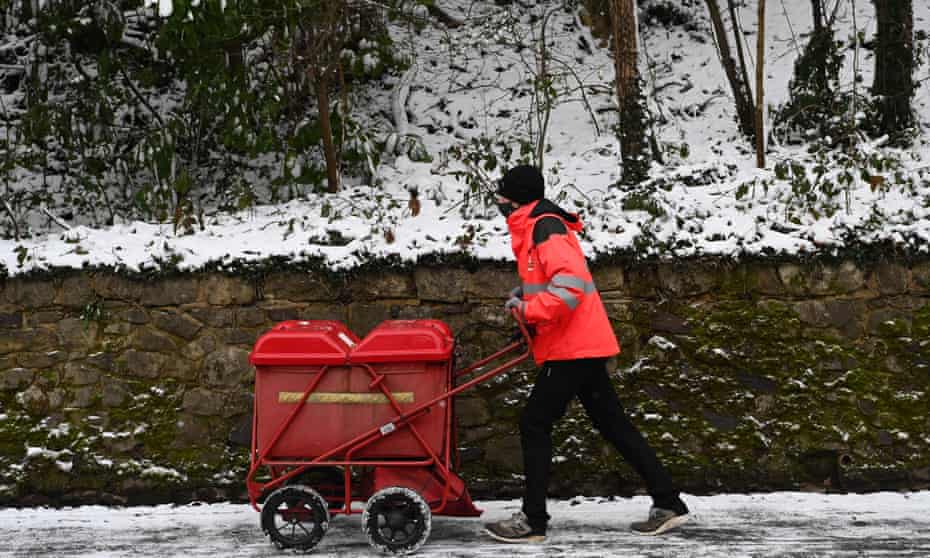 A postman on his round in Sevenoaks, Kent, but more than 120 UK districts have suffered problems with deliveries