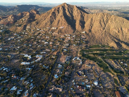 Aerial view of Scottsdale, Arizona, showing a rugged mountain amid desert homes and a golf course