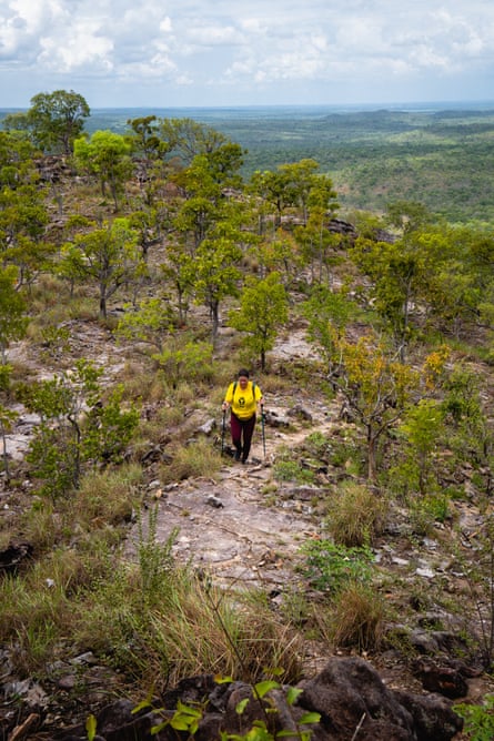 A hiker in a yellow top on the Caminhos de Ibiapaba trail, in the Cerrado biome.
