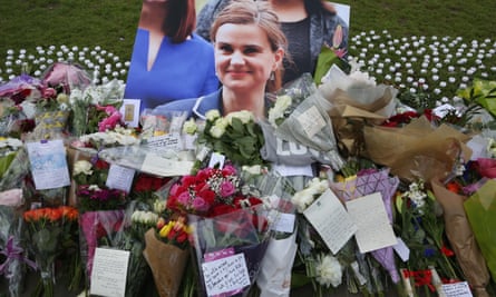 Flowers and tributes placed around a picture of Jo Cox