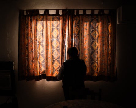 A small person silhouetted against a curtain