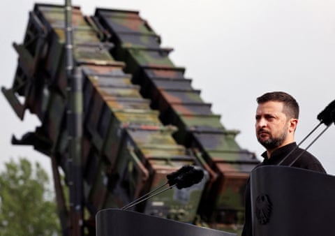 Volodymyr Zelenskyy standing in front of a US-made Patriot anti-aircraft missile system