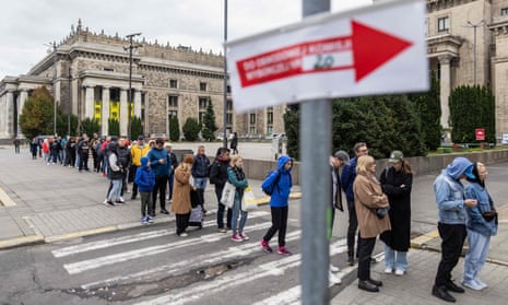 Voters queue in front of the polling station at the Palace of Culture in Warsaw, Poland on 15 October 2023, during parliamentary elections.