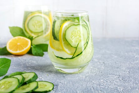 Glasses of iced water with added fresh cucumber and lemon