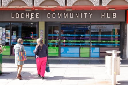 Two people walk towards Lochee Community Hub