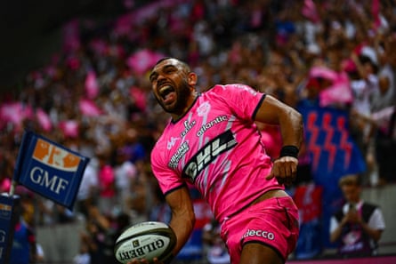 Joe Marchant celebrates a try holding a rugby ball