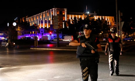 Police officers stand guard near the Turkish military headquarters in Ankara, Turkey.