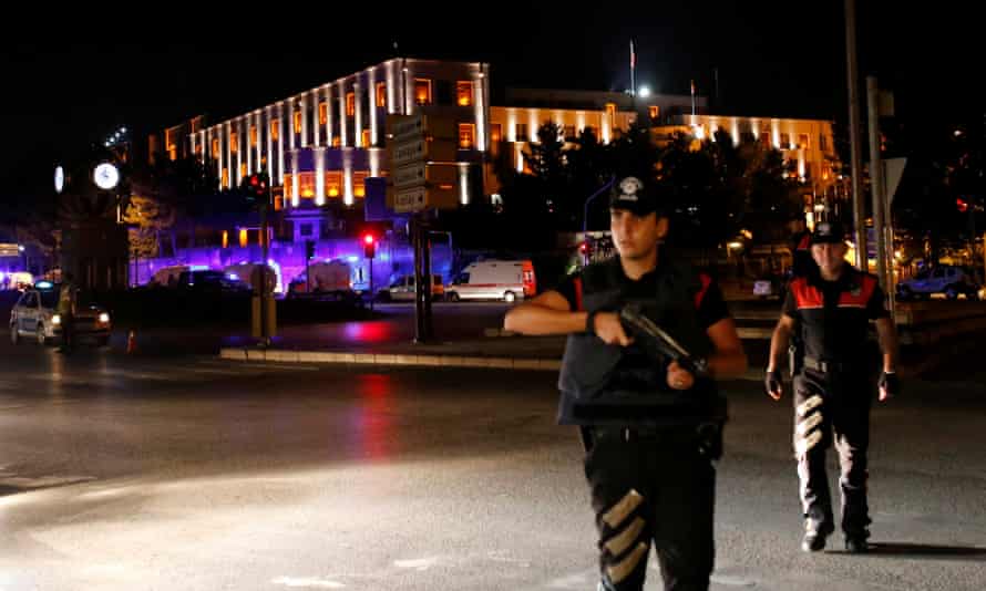 Police officers stand guard near the Turkish military headquarters in Ankara, Turkey.